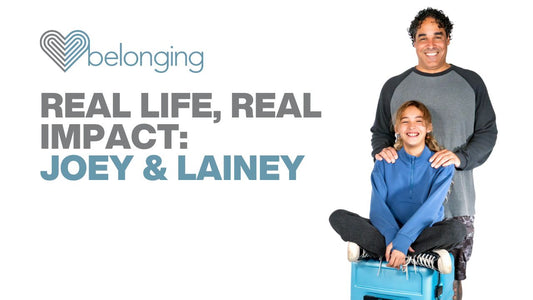Joey standing behind Lainey as she sits on a blue Belonging LifeLocker, beside the Belonging logo and the text “Real Life, Real Impact: Joey & Lainey” on a light background.
