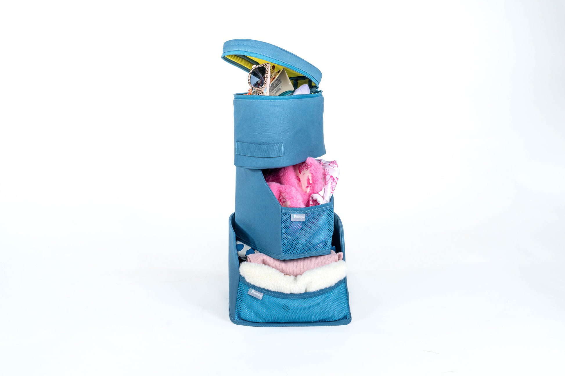 Blue Belonging LifeLocker Founders Bundle removable organizer shown open and filled with clothing, accessories, and personal items, featuring mesh storage pockets on a white studio background.