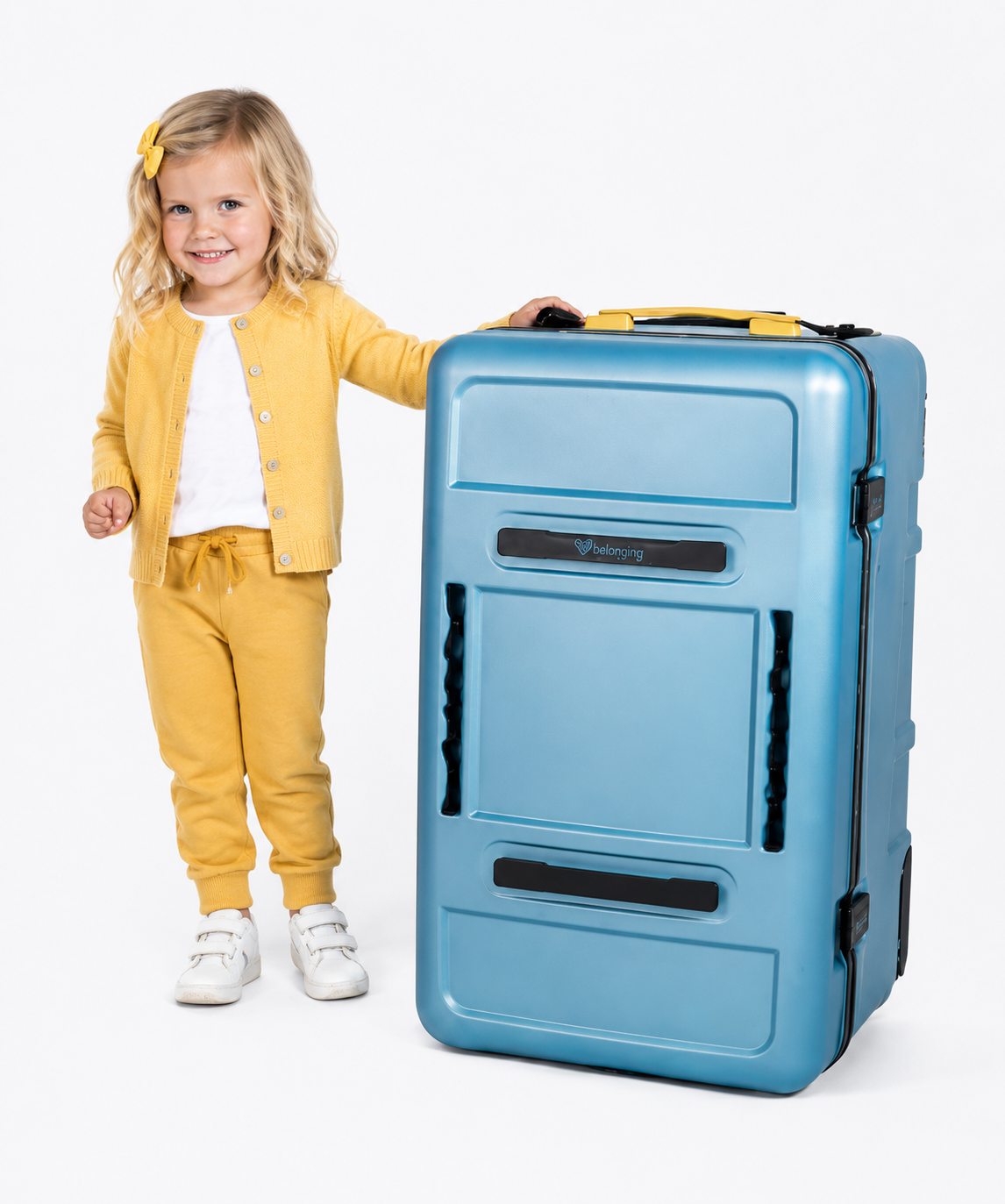 Child in yellow outfit standing next to a blue transition system on a white background